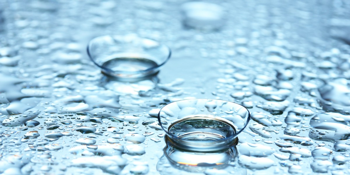 Contact lens on female finger, close up view. Medicine and vision concept