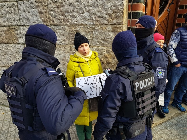 Policja legitymuje protestującą osobę.