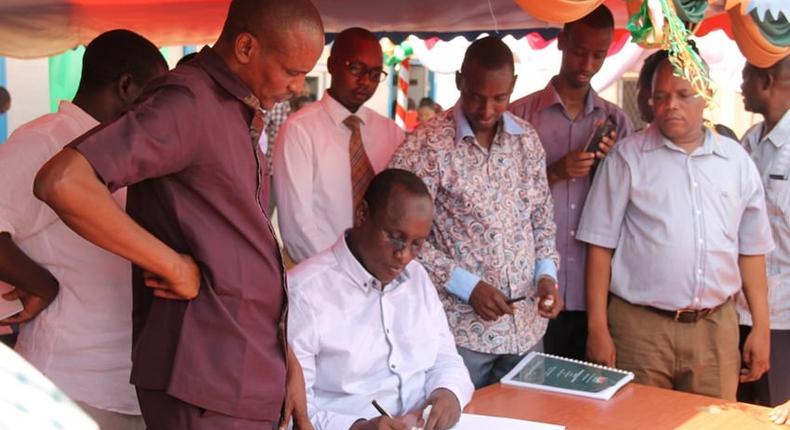 File image of former Tana River Governor Hussein Dado signing documents