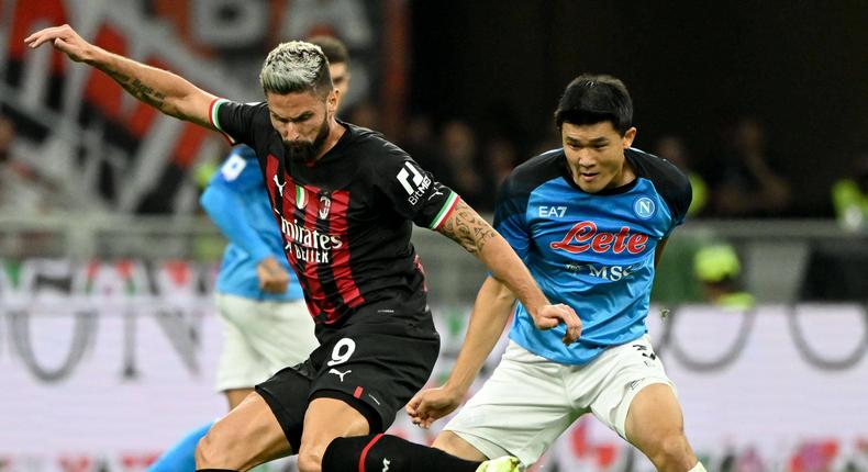 AC Milan's Olivier Giroud (L) vies with Napoli s Kim Min-Jae during a Serie A football match between AC Milan and Napoli in Milan, Italy, on September 18, 2022