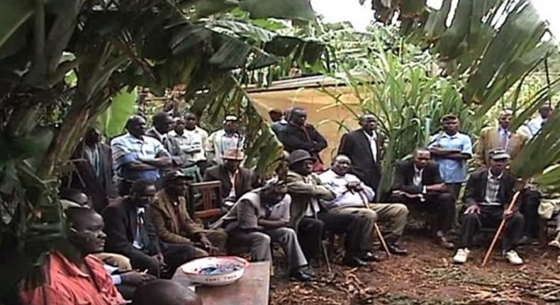 The shocked villagers at the site of the arson