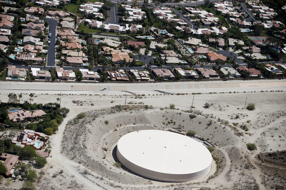 A parched water-storage facility near homes in La Quinta.