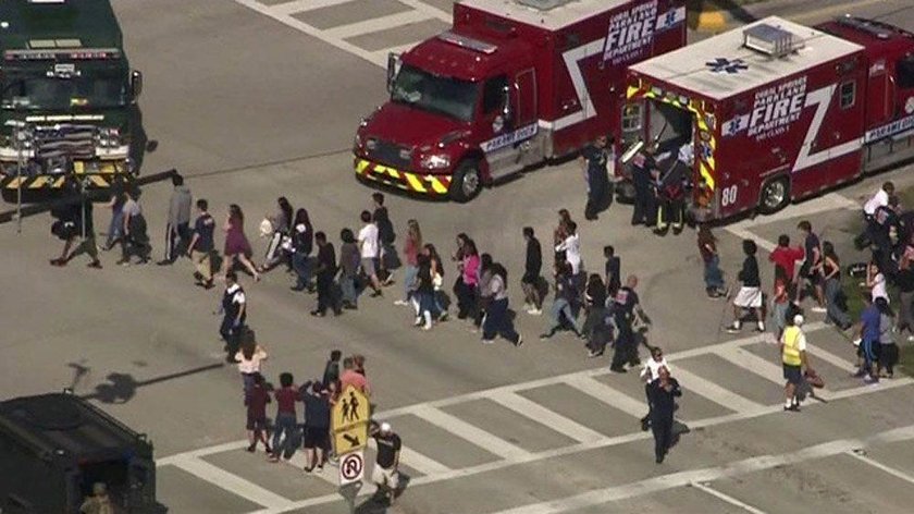 Students are evacuated from Marjory Stoneman Douglas High School during a shooting incident in Parkl