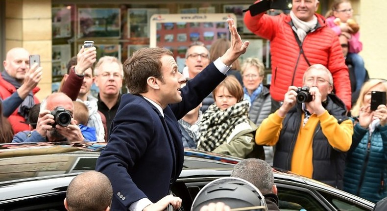 French centrist presidential candidate Emmanuel Macron greets supporters as France votes in the first round of an unpredictable election