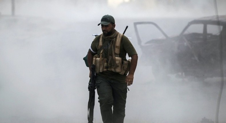 A Hashed al-Shaabi fighter carries a rocket-propelled grenade launcher in Tal Afar on August 26, 2017