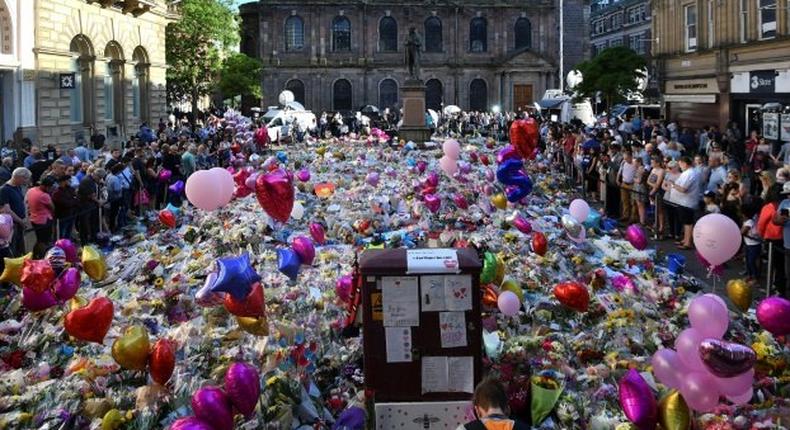 Flowers, toys and balloons cover St Ann's Square in central Manchester to honour the 22 people killed at the concert attack