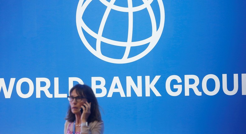 FILE PHOTO: A participant stands near a logo of World Bank at the International Monetary Fund - World Bank Annual Meeting 2018 in Nusa DuaReuters