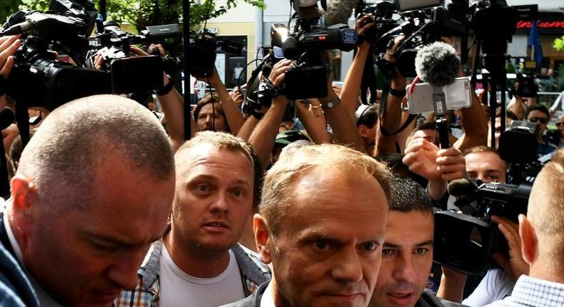 Donald Tusk (c), EU president and former Polish prime minister, arrives at the prosecutor's office to testify as a witness in the investigation of the 2010 plane crash that killed President Lech Kaczynski.