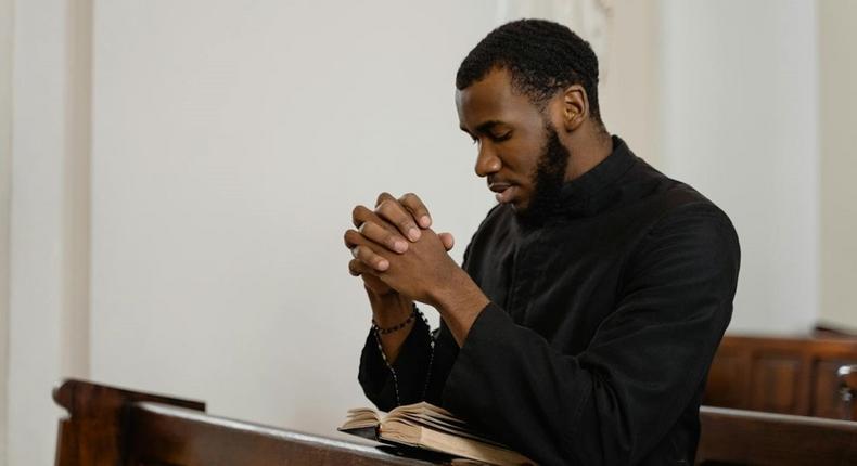 A religious man praying solemnly [Image Credit: Mart Production]