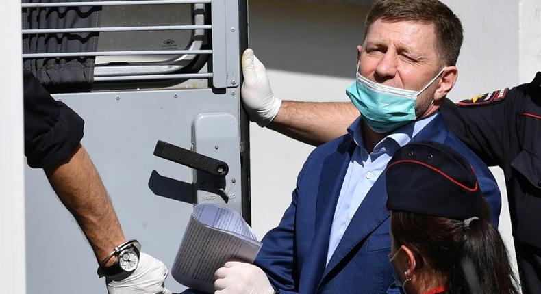 Khabarovsk region governor Sergei Furgal is escorted into a police van after a court hearing in Moscow on July 10