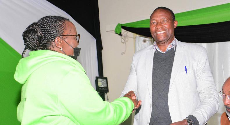 Governor elect of Nyandarua Moses Badilisha Kiarie is presented his election certificate by an IEBC official