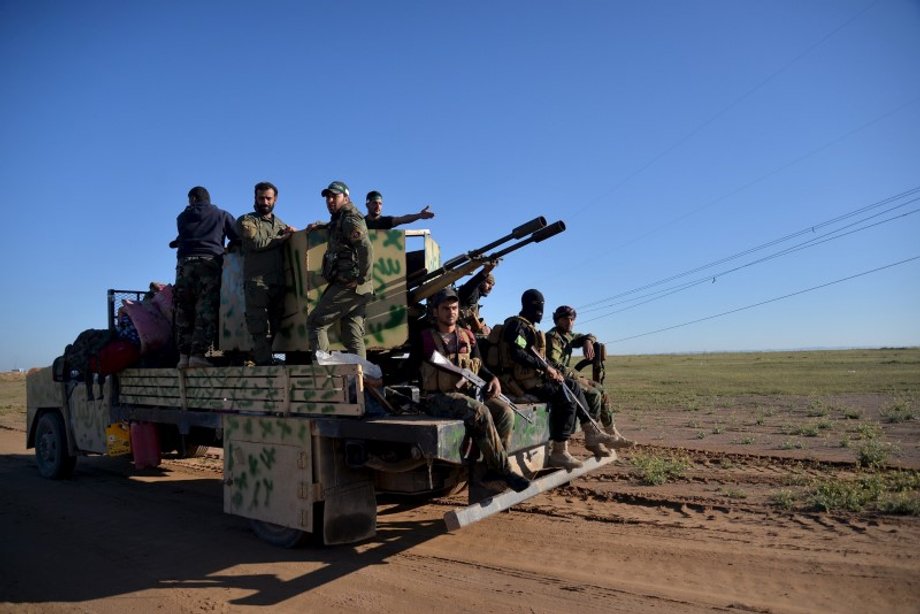 Members of the Hashid Shaabi Shiite militia gather in the west of Samarra, in the desert of Anbar, as they prepare to depart for Mosul to fight against ISIS.