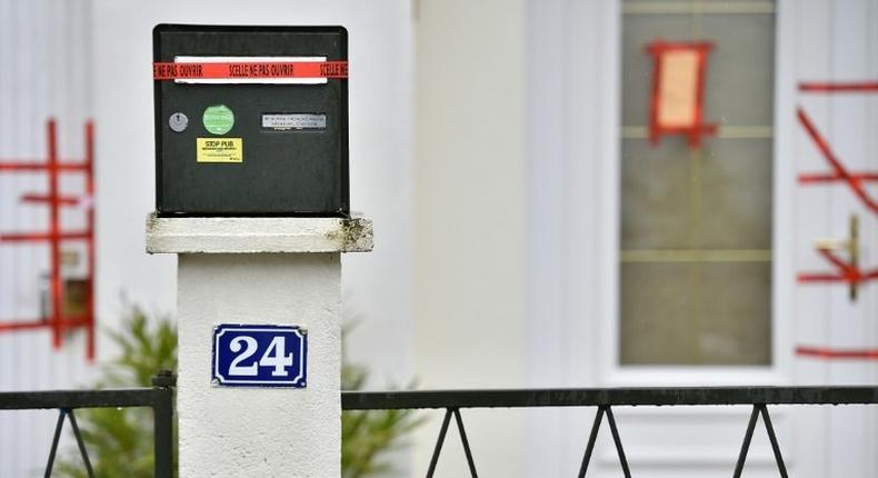 Police sealed displayed on the mail box and the entrance of the house of the Troadec family, the day after the brother in law of the father, Hubert Caouissin confessed the killing of all four members of the family