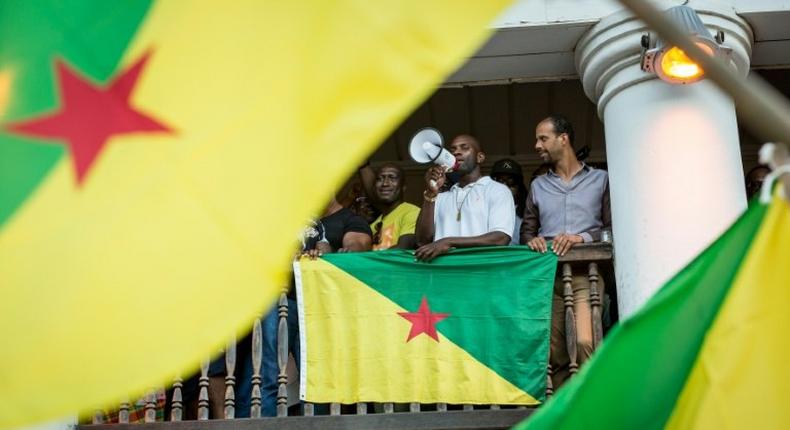 Representatives of the collective 500 freres announce to a cheering crowd the signing of an agreement with the government in Cayenne, French Guiana on April 21, 2017