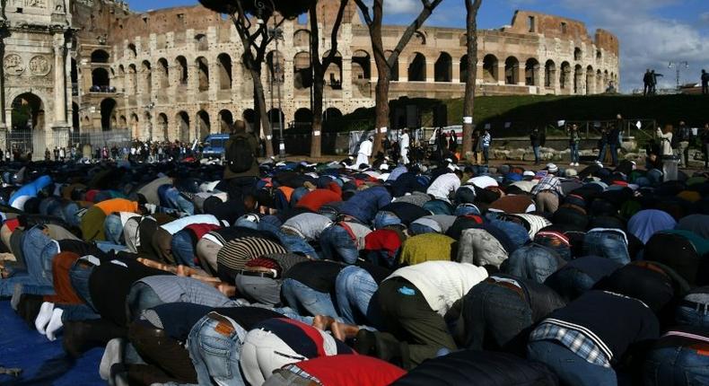 Muslim men attend the Friday prayers during a demonstration near Rome's ancient Colosseum