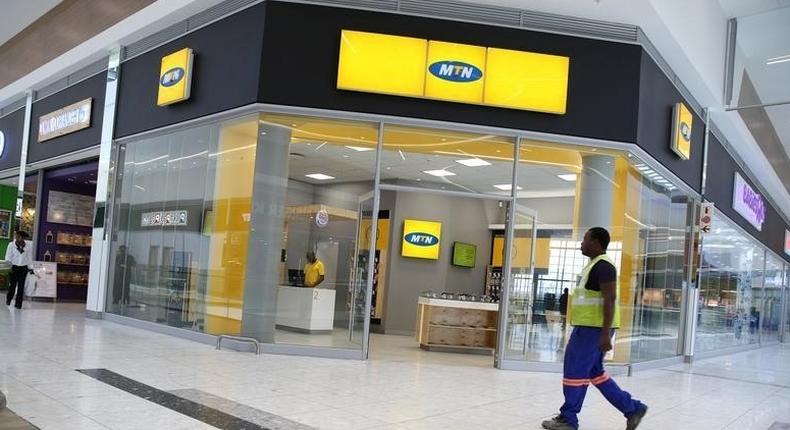 A worker walks past an outlet of South Africa's MTN Group in Johannesburg, South Africa