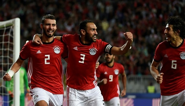 Egypt defenders Baher El-Mohamady (L) celebrates with his Ahmed Elmohamady (C) and Ahmed Hegazi (R) after scoring a goal during the Africa Cup of Nations qualifier football match against Tunisia near Alexandria November 16, 2018 