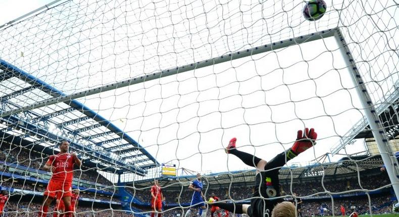 Leicester City's goalkeeper Kasper Schmeichel falls after failing to stop a goal by Chelsea's Diego Costa during their English Premier League match, at Stamford Bridge in London, on October 15, 2016