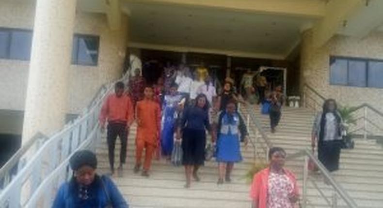 Federal High Court Abuja staff leaving the office for their various homes shortly after the instruction from the National Judicial Council (NJC) on Wednesday.  [NAN]