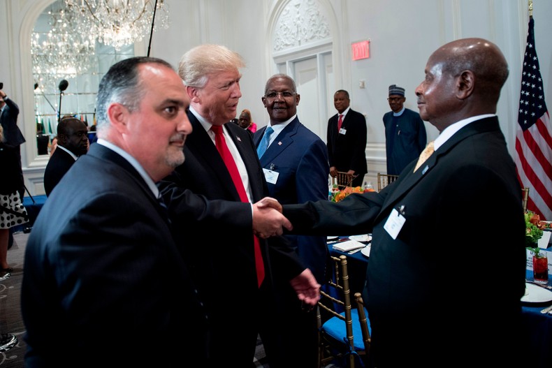 US President Donald Trump (C) greets Uganda's President Yoweri Museveni (R) before a luncheon with US and African leaders at the Palace Hotel during the 72nd United Nations General Assembly on September 20, 2017, in New York.  [Photo by BRENDAN SMIALOWSKI/AFP via Getty Images]