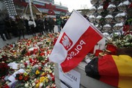 Flowers and candles are placed near the Christmas market at Breitscheid square in Berlin