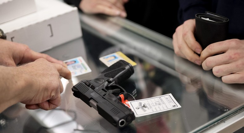 TINLEY PARK, ILLINOIS - APRIL 08: A customer purchases a gun at Freddie Bear Sports on April 08, 2021 in Tinley Park, Illinois. President Joe Biden today announced gun control measures which included stricter controls on the purchase of homemade firearms, commonly referred to as Ghost Guns and he made a push for national Red Flag legislation and other measures.