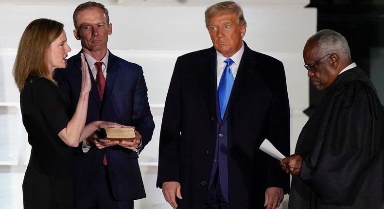 President Donald Trump watches as Supreme Court Justice Clarence Thomas administers the Constitutional Oath to Amy Coney Barrett on the South Lawn of the White House White House in Washington on October 26, 2020.Alex Brandon/AP