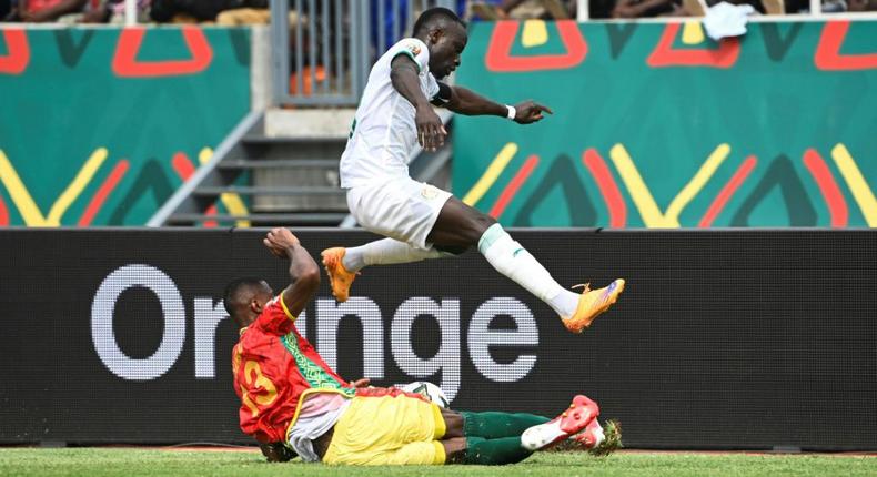 Senegal captain and forward Sadio Mane (R) evades a tackle by Guinea defender Issiaga Sylla during an Africa Cup of Nations Group B match in Bafoussam on Friday.