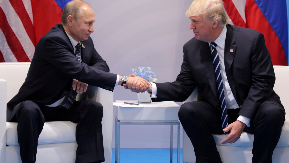 FILE PHOTO - U.S. President Donald Trump shakes hands with Russia's President Vladimir Putin during 