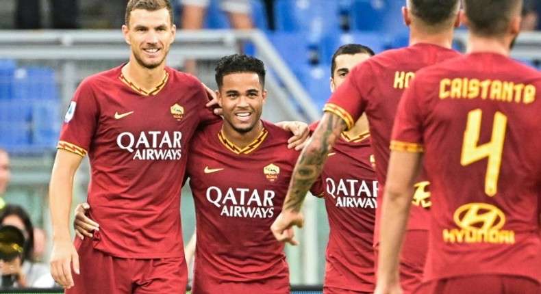 AS Roma's Dutch forward Justin Kluivert (2ndL) celebrates with Bosnian Edin Dzeko (L) after scoring his team's fourth goal against Sassuolo.