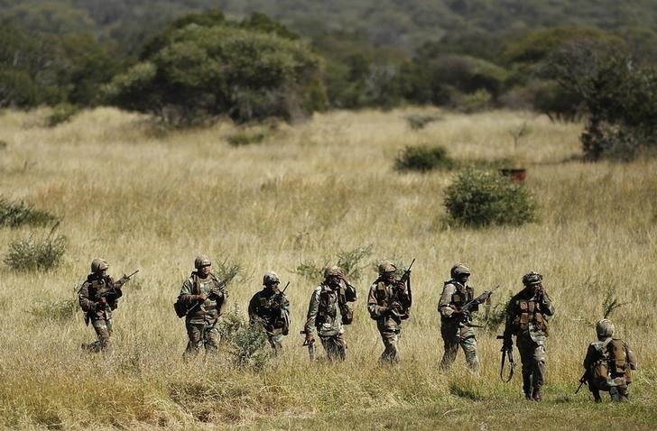 Members of the South African National Defence Force (SANDF) return after taking part in a Capability Demonstration at the Roodewal Bombing Range in Makhado, in the northern province of Limpopo, May 9, 2013. REUTERS/Siphiwe Sibeko