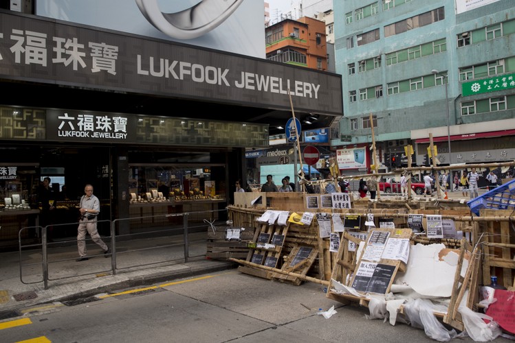 Hongkong jest najbardziej rozwarstwionym państwem należącym do rozwiniętego świata – twierdzi Paul Schulte, szef firmy badawczej Schulte-Research z siedzibą w Hongkongu. Do 30 proc. najbiedniejszych obywateli należy jedynie 6,4 proc. kapitału, podczas gdy najbogatsze 30 proc. posiada aż 70 proc. Schulte uważa, że odpowiedzialna jest za to elita polityczna i biznesowa, które współpracują ze sobą. <br> Na zdj. barykada przed sklepem Lukfook Biżuteria, należącym do Luk Fook Holdings International Ltd., w dzielnicy Mong Kok.