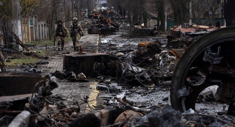 Soldiers walk amid destroyed Russian tanks in Bucha, in the outskirts of Kyiv, Ukraine, April 3, 2022.AP Photo/Rodrigo Abd, File