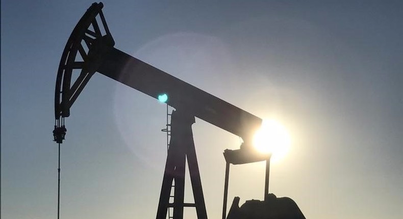 An oil rig drilling a well at sunrise near Midland, Texas