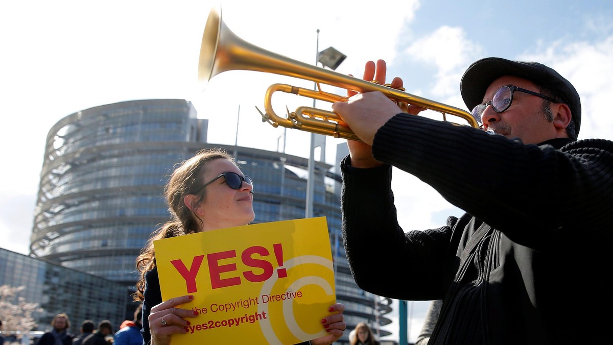 Demonstrators take part in a protest in front of the European Parliament as MEPs debate on modificat