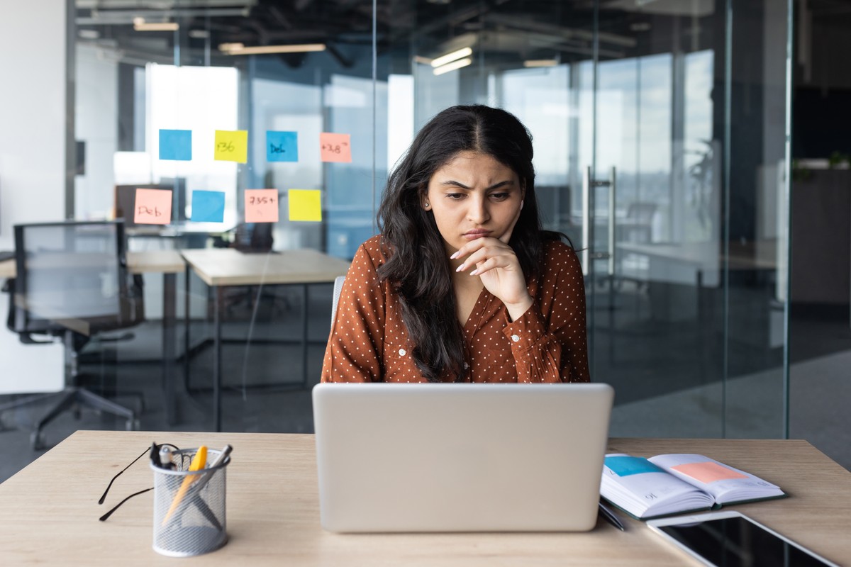 Serious,Thinking,Businesswoman,At,Work,With,Laptop,Inside,Office,,Female