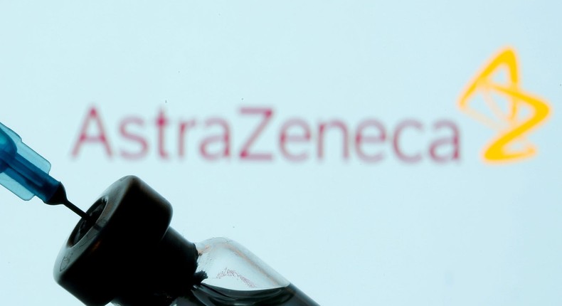 A vial and syringe in front of the AstraZeneca logo.
