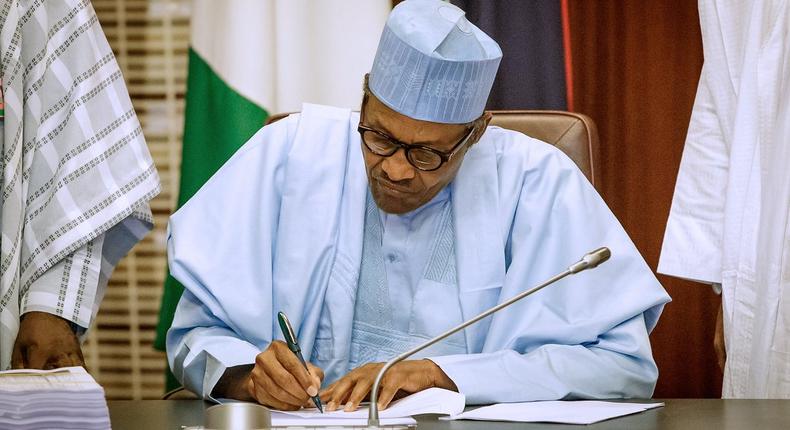 President Muhammadu Buhari signing the 2019 Budget into Law at the State House; 27th May 2019. (Twitter/Aso Rock)