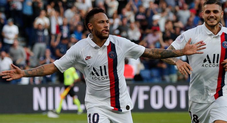 PSG's Neymar, left, celebrates his goal with PSG's Mauro Icardi during the French League One soccer match between Paris Saint Germain and Strasbourg at the Parc des Princes Stadium in Paris, France, Saturday Sept.14, 2019. (AP Photo/Francois Mori)