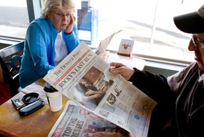 Vicki, left, and Dan Rubin look at the final edition of the