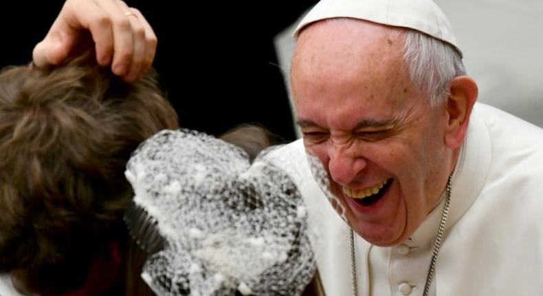 Pope Francis laughs as he greets people during his weekly general audience at the Paul VI audience Hall on December 7, 2016 in Vatican