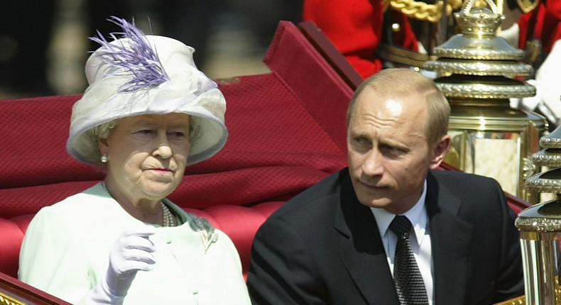 Russian President Vladimir Putin is accompanied by Queen Elizabeth II during a procession at The Mallat during the start iof his state visit on June 24, 2003 in London, England.