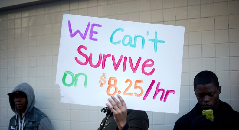 Protesters calling for higher wages for fast-food workers stand outside a McDonald's restaurant in Oakland, California on December 5, 2013.REUTERS/Noah Berger