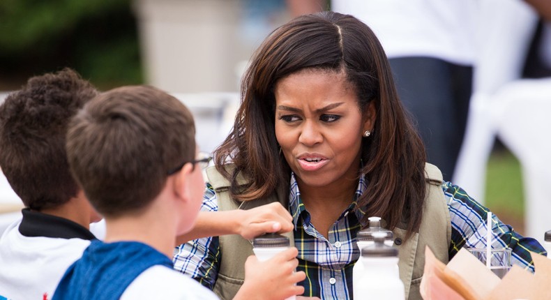 Michelle Obama sits down for a meal with children on the South Lawn of the White House in 2016.Cheriss May/NurPhoto via Getty Images