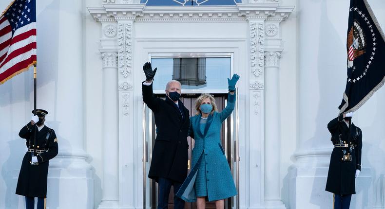 President Joe Biden and first lady Jill Biden wave as they arrive at the North Portico of the White House on January 20, 2021.
