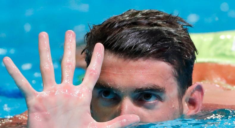 Michael Phelps holds up five fingers during the finals for the men's 200 meter butterfly in the U.S. Olympic swimming team trials at CenturyLink Center.