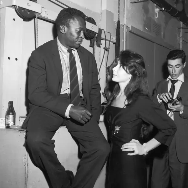 1958: Juliette Greco and Miles Davis at the club Saint Germain In Paris, France In 1958. (Photo by Andre SAS/Gamma-Rapho via Getty Images)