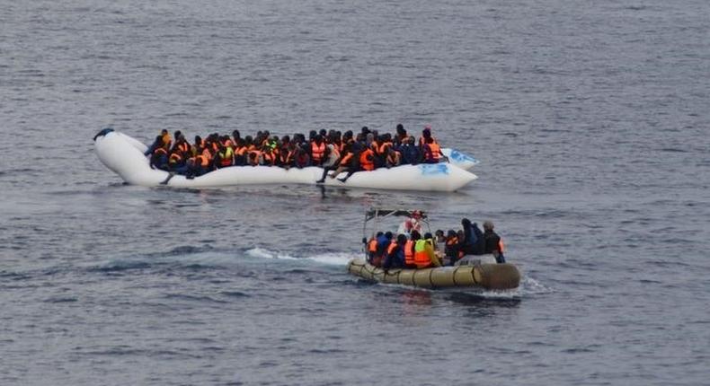 Migrants sit in their boat during a rescue operation of 219 migrants by Italian naval vessel Bettica (not seen) in this February 23, 2016 handout picture provided by Marina Militare. REUTERS/Marina Militare/Handout via Reuters
