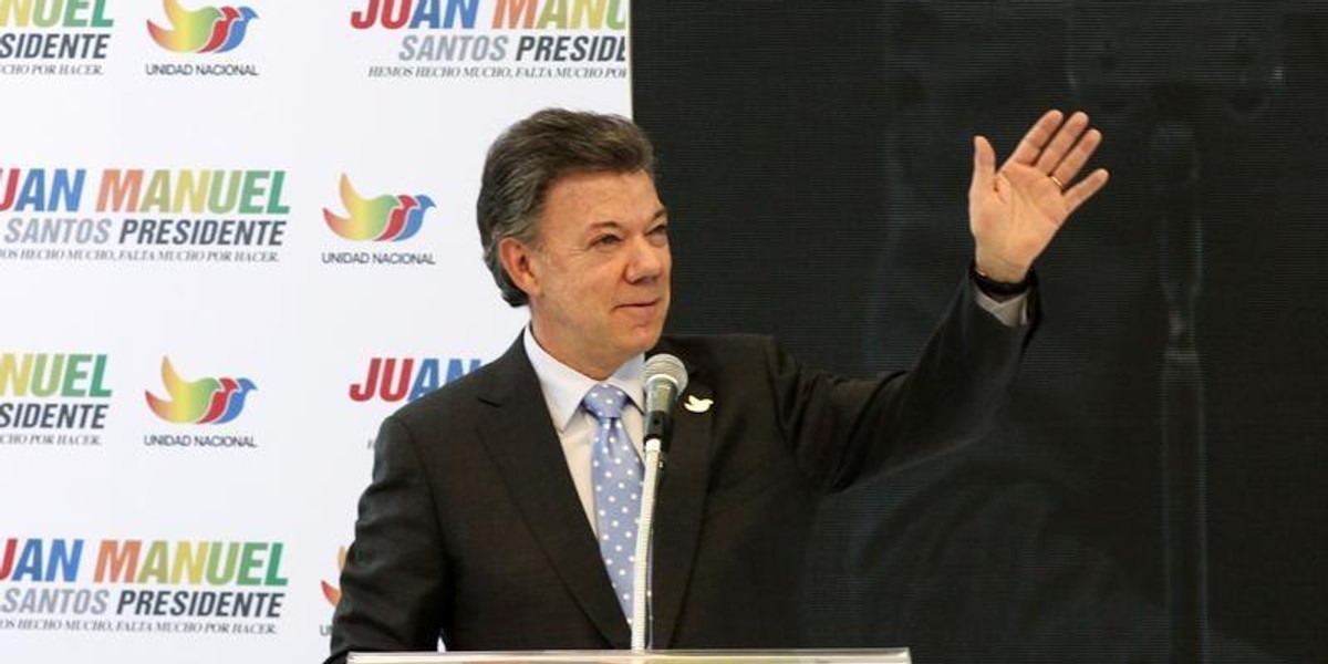 Colombia's President Juan Manuel Santos greets supporters during a campaign rally in Bogota