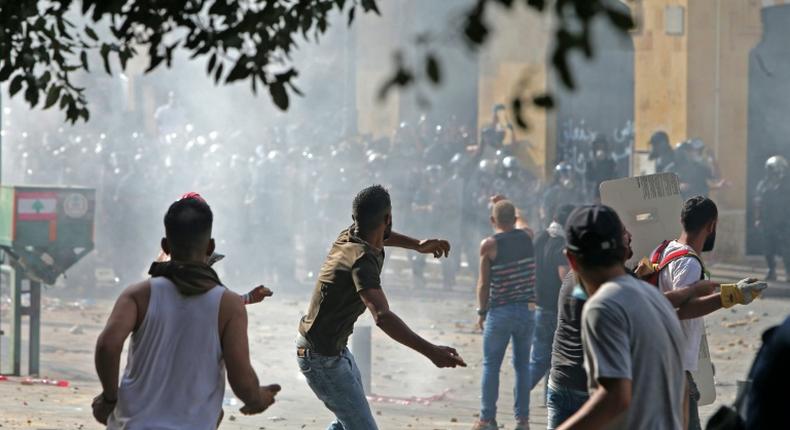 Lebanese protesters hurl rocks towards security forces during clashes in downtown Beirut